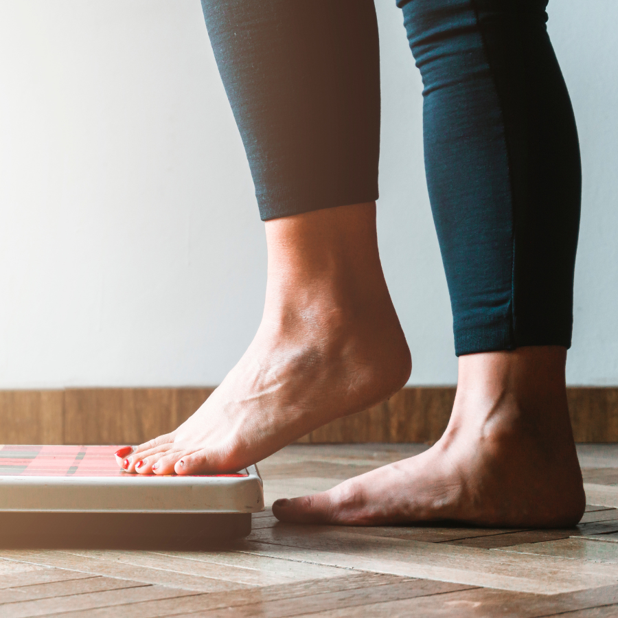 Obesity woman stepping on scale